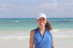 Celi of Soul Trips and an Up with People Alumna stands on the beach