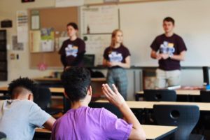 Up with People gap year students volunteer abroad at a school with children